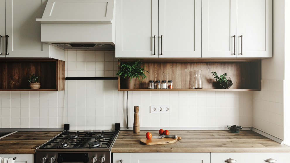 Farmhouse kitchen with custom cabinetry, wooden open shelves, and a white tiled backsplash