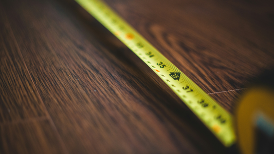 Yellow measuring tape on wood