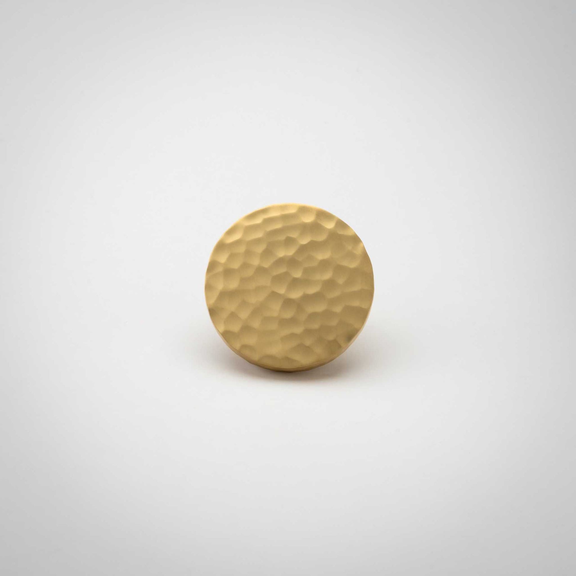 Strike, Hammered Solid Brass Cabinet KnobsOur Strike knob is hand-hammered for a stylish twist on the traditional cabinet knob. Provides a subtle sparkle to your transitional cabinet doors and drawers.KnobStrike, Solid Brass Hammered Cabinet Knobs