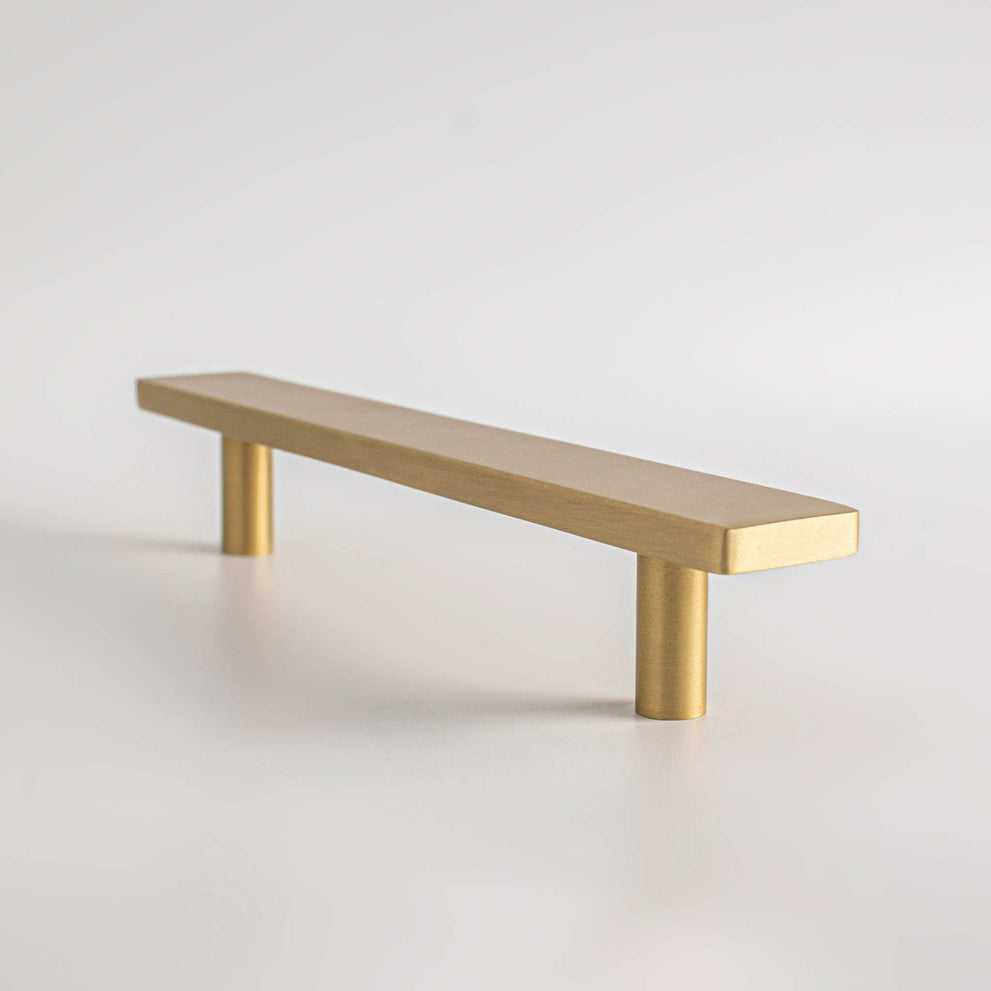 Auburn cabinet pull with a brushed brass surface
