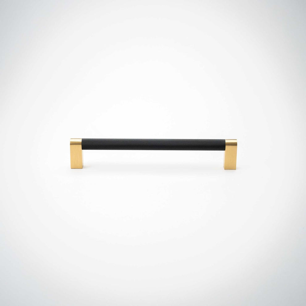 Bold cabinet pull showing its two brass mounting feet