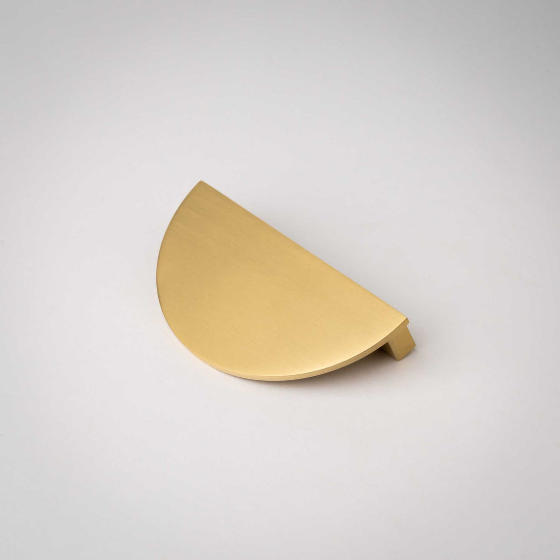 Demi Lune cabinet pull showing its broad finished face