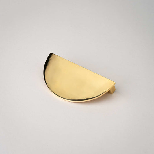 Demi Lune pull with a new unlacquered polished brass finish