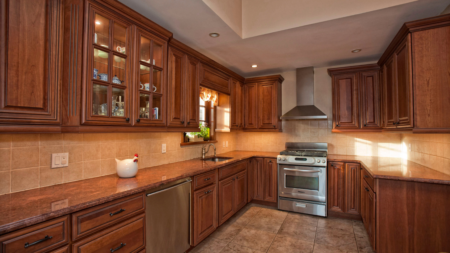 Kitchen With Dark Wood Cabinets And Granite Countertops Featuring Black Cabinet Hardware