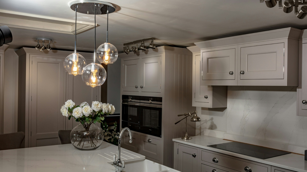 Modern Kitchen With Light Gray Cabinetry And Integrated Appliances