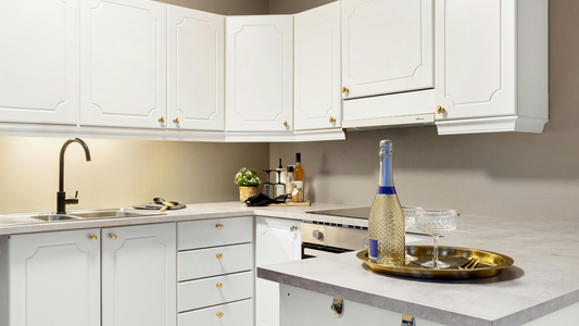 Modern White Kitchen Featuring Classic Raised-Panel Cabinetry With Satin Brass Cabinet Knobs