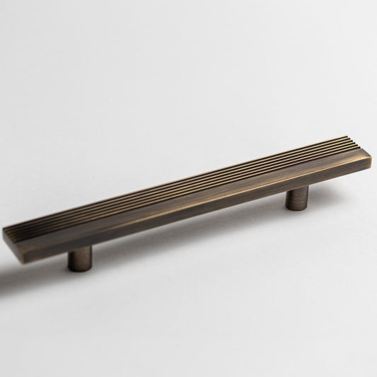 Rail cabinet pull showing its grooved face