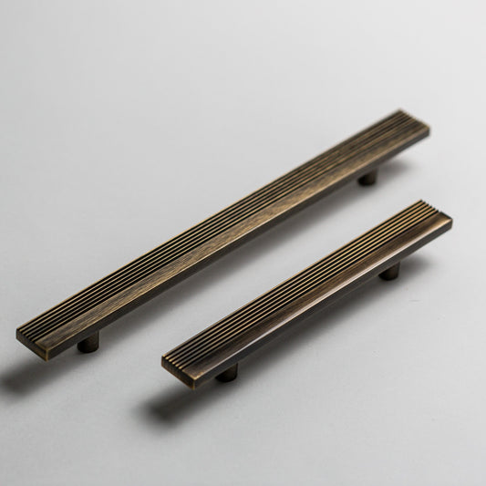 Rail cabinet pulls in Antique Brass
