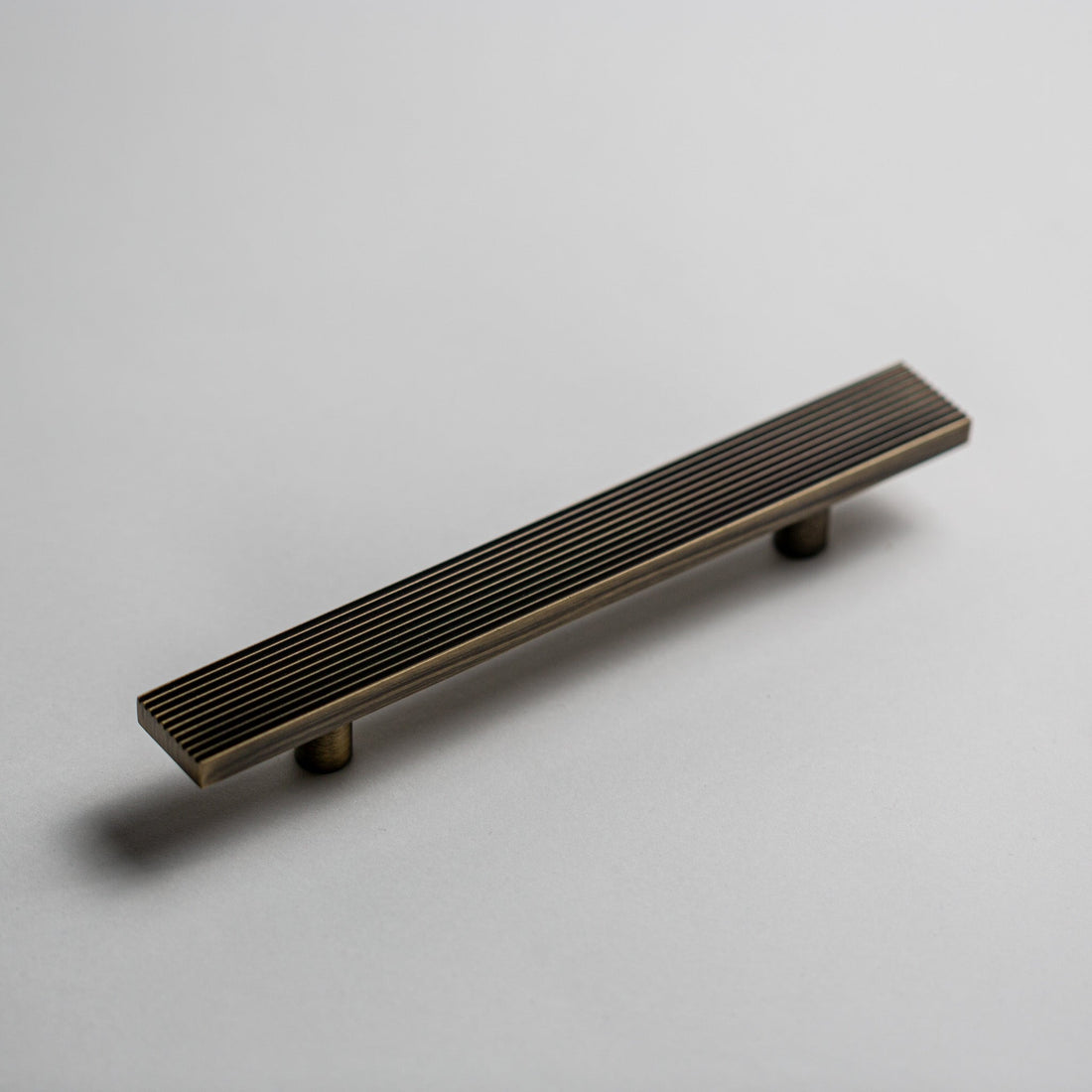 Rail cabinet pull in Antique Brass