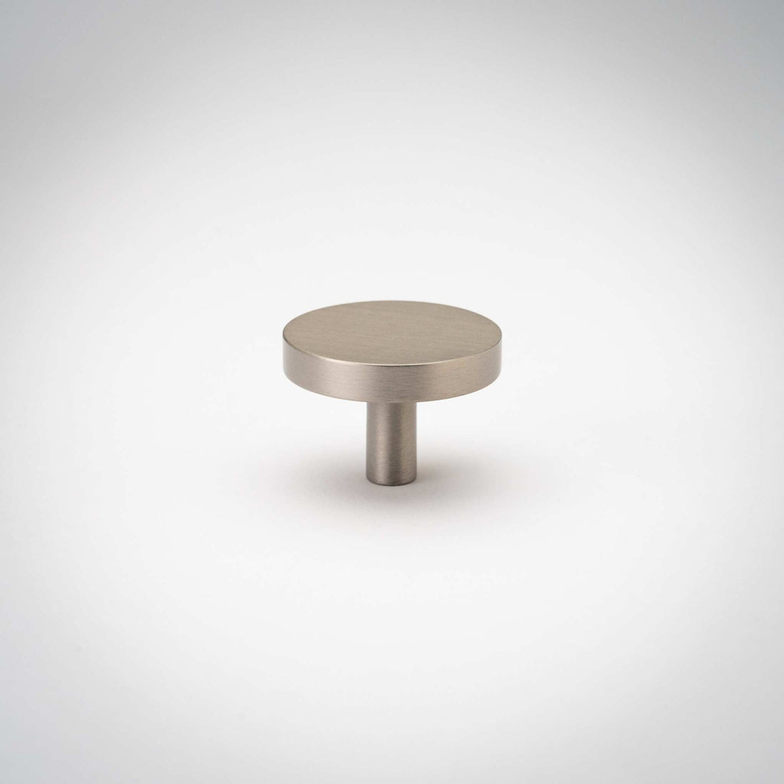 Rondelle cabinet knob with a satin nickel-colored surface