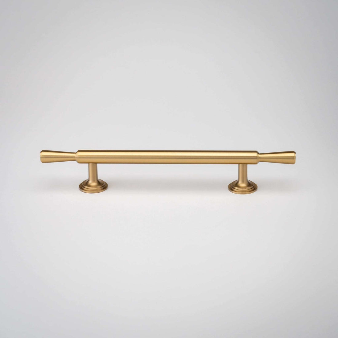 Tuxedo cabinet pull with a slim brass bar