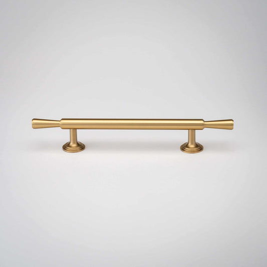 Tuxedo cabinet pull with a slim brass bar