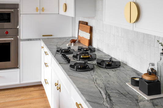Oblique view of white kitchen cabinet fronts with Demi Lune and Orbital hardware