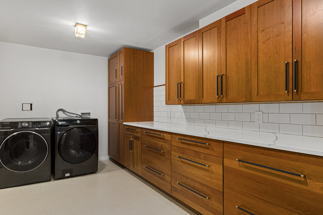 Wood laundry cabinetry with Bold pulls aligned across the drawer fronts