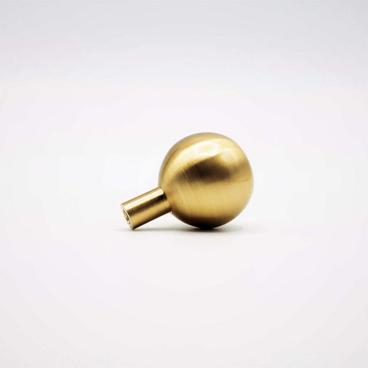 Dumas ball knob with a satin brass surface