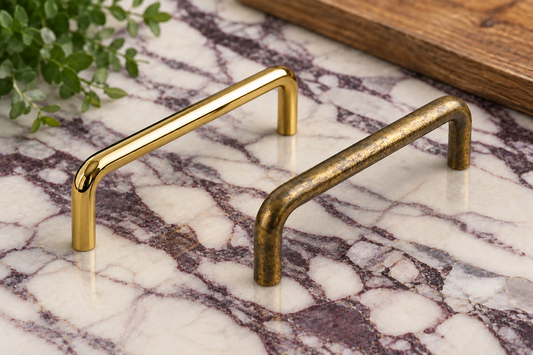 AI-assisted illustration of Inspire Arch pulls in polished and aged brass on Calacatta Viola marble