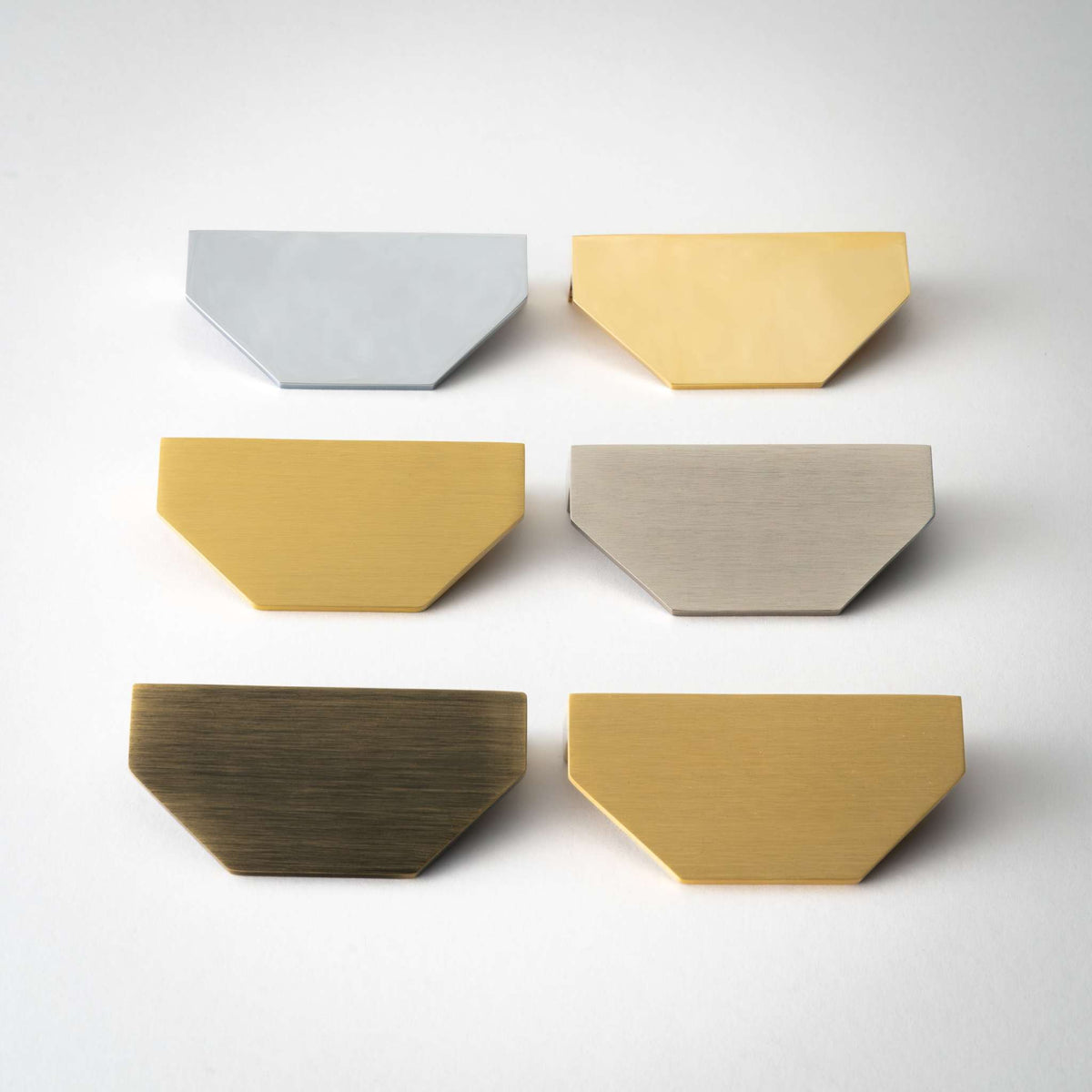 Six Alto half-hexagon cabinet pulls in assorted finishes