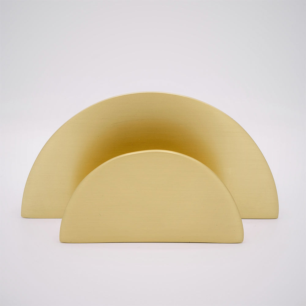 Two semicircular cabinet pulls showing their relative sizes