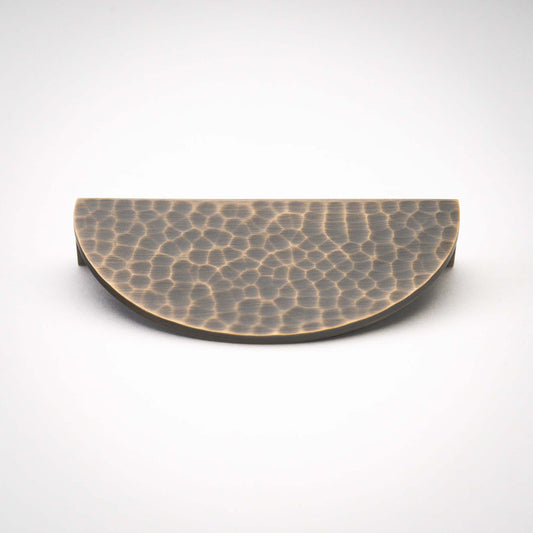 Hammered Demi Lune, Solid Brass Half Moon Cabinet PullsThis Demi Lune Hammered Pull is crafted from solid brass and finished with a unique hammered texture. With its half-moon shape, it's a charming addition to any kitchpullHammered Demi Lune, Solid Brass Half Moon Pulls