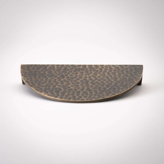 Hammered Demi Lune, Solid Brass Half Moon Cabinet PullsThis Demi Lune Hammered Pull is crafted from solid brass and finished with a unique hammered texture. With its half-moon shape, it's a charming addition to any kitchpullHammered Demi Lune, Solid Brass Half Moon Pulls